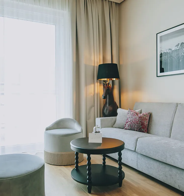 Modern eingerichteter Wohnbereich der Sisi Suite im Grand Elisabeth, mit stilvoller Pferdelampe als Blickfang im Designhotel in Bad Ischl.